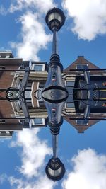 Low angle view of street light against buildings in city