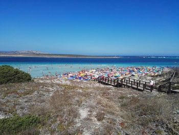 Scenic view of beach against clear blue sky