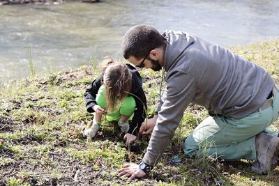 Father and daughter playing at riverbank0ll