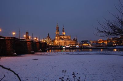 View of illuminated city during winter at night