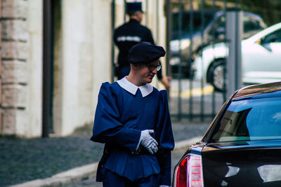 Full length of man standing by car