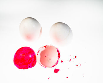 High angle view of multi colored candies against white background