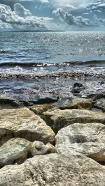 Scenic view of sea against cloudy sky