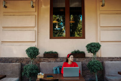 Portrait of woman sitting on table