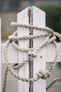 Close-up of rope tied to wooden post