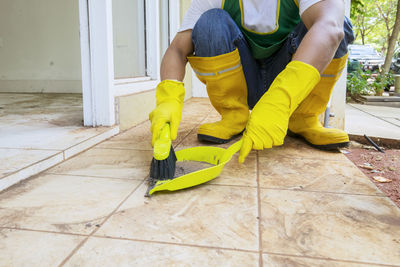 Low section of man working on tiled floor