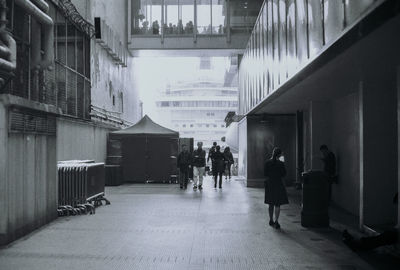 People walking in corridor of building