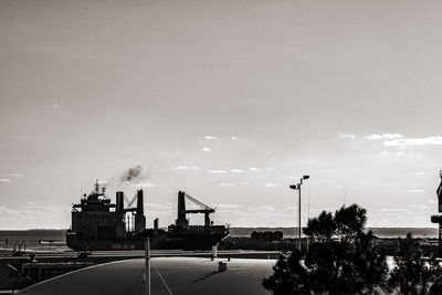 Cars on street against sky in city