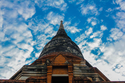Low angle view of temple building against cloudy blue sky