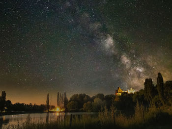 Scenic view of lake against star field at night