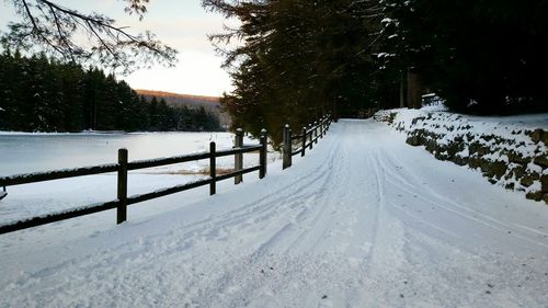 Scenic view of lake against sky during winter