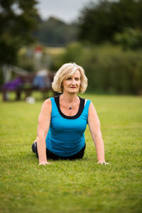 Portrait of woman sitting on grass