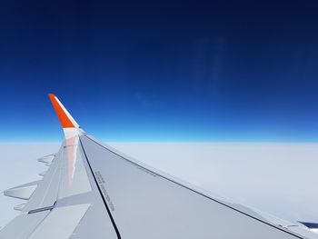 Low angle view of wind turbine against blue sky