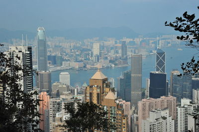 Aerial view of buildings in city against sky