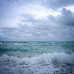 Scenic view of sea against cloudy sky