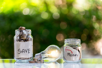 Close-up of coins in glass jar on table