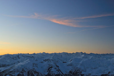 Scenic view of snow mountains against blue sky