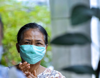 Portrait of mature woman wearing mask