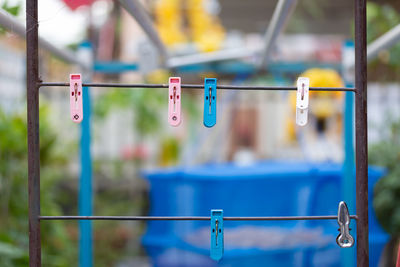 Close-up of clothespins on metal