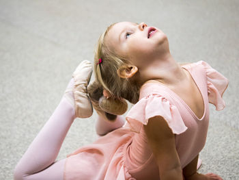 Cute girl dancing ballet on floor