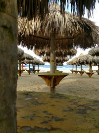 Close-up of gazebo on beach against trees