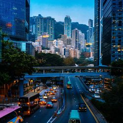 Traffic on city street by modern buildings