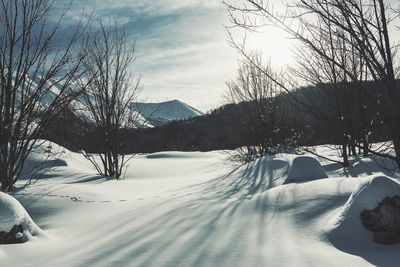 Scenic view of snow covered mountains against sky