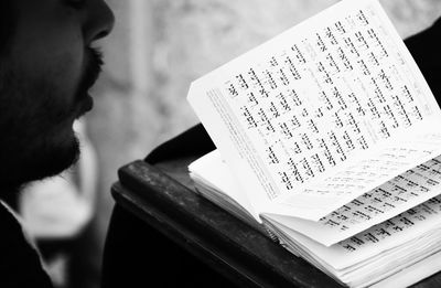 Close-up of man reading book