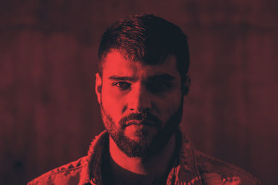 Portrait of young man against wall