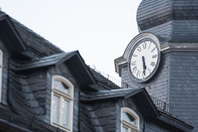 Low angle view of clock tower against building