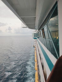 Ship sailing in sea against sky