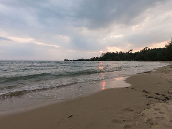 Scenic view of beach against sky during sunset