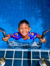 Portrait of smiling boy in swimming pool