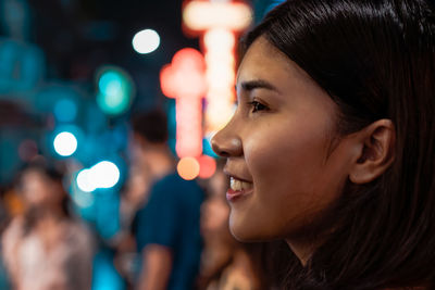 Close-up portrait of young woman looking away
