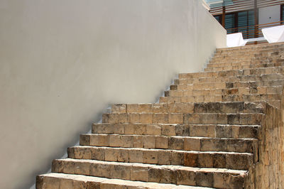 Staircase in front of brick wall