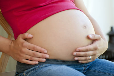 Midsection of woman touching baby