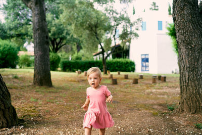 Full length of a woman with pink flowers