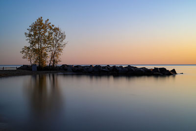 Scenic view of sea against clear sky during sunset