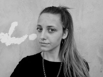 Portrait of woman against wall