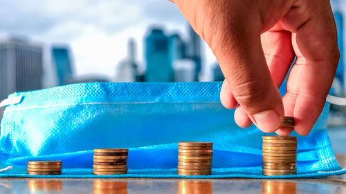 Close-up of hands holding blue stack