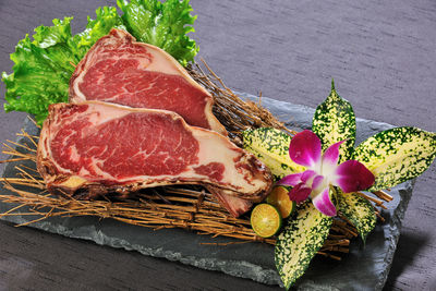 Meat and flower on slate over table