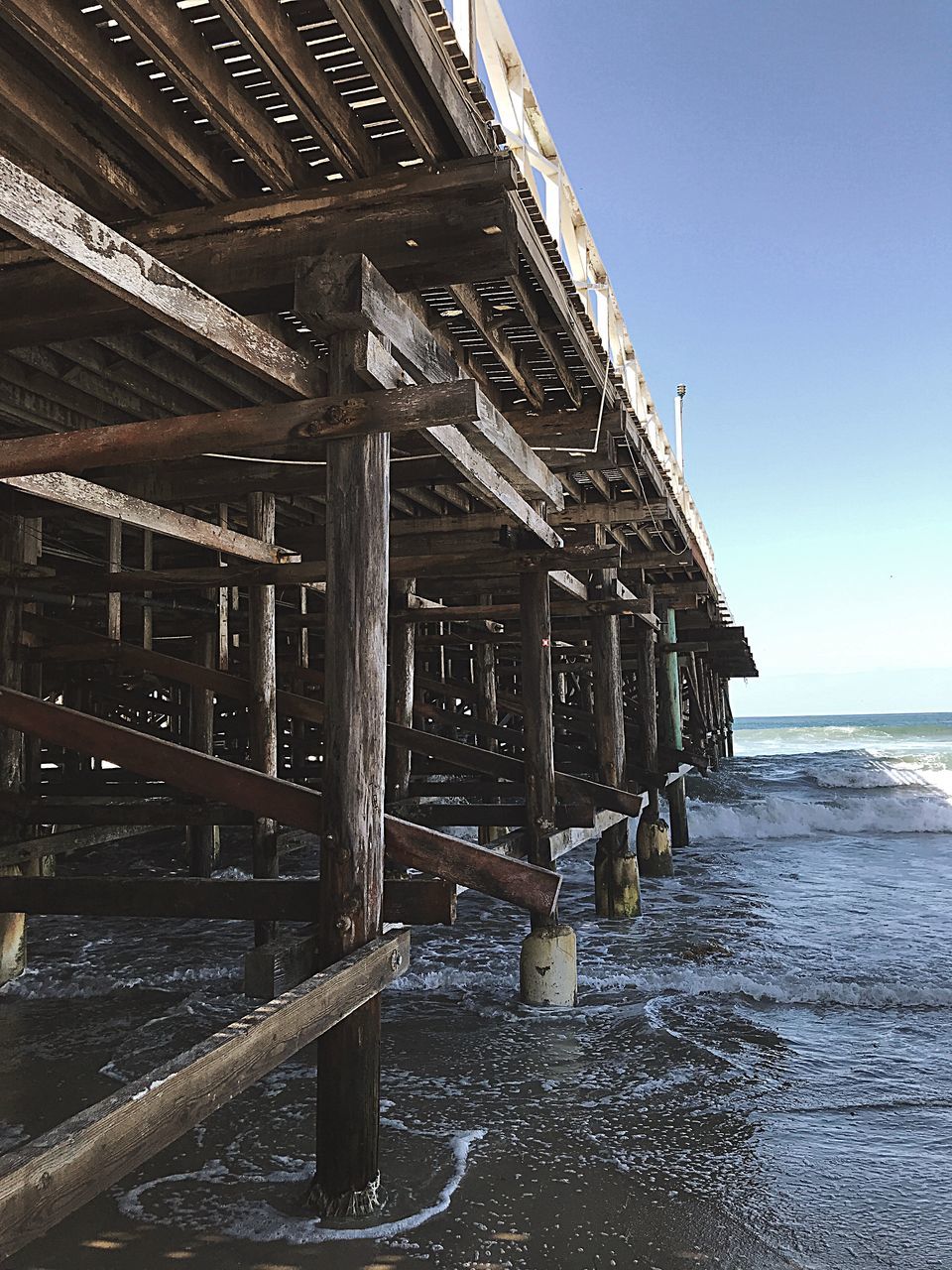 water, built structure, architecture, sea, wood - material, sky, nature, no people, beach, land, building exterior, day, building, pier, clear sky, tranquility, beauty in nature, scenics - nature, outdoors, horizon over water, architectural column, wooden post