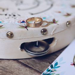 Close-up of gold wedding rings on tambourine