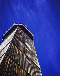 Low angle view of modern building against clear blue sky