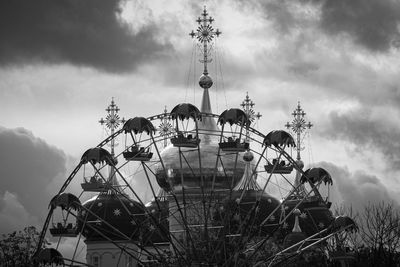 Low angle view of ferris wheel against sky