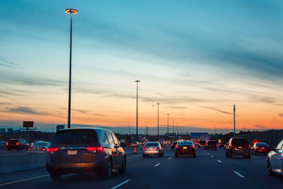 Night traffic, cars on highway road on sunset evening night in busy city, urban view