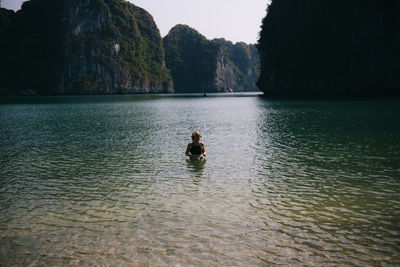 Woman swimming in lake against sky