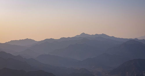 Scenic view of mountains against clear sky during sunset