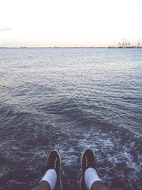 Low section of people relaxing on beach