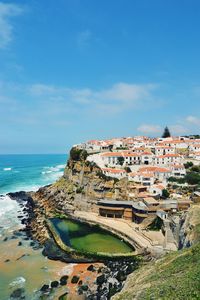 Scenic view of sea and buildings against sky